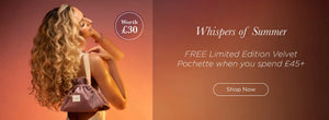 Woman holding limited edition pochette with against sunset background - Spend £45 receive a free Velvet Pochette